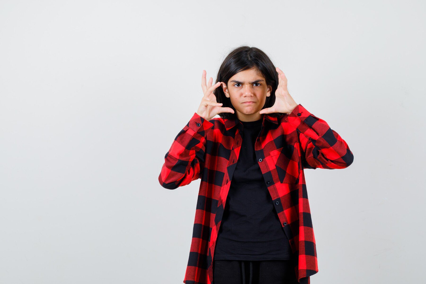 portrait-teen-girl-keeping-hands-near-face-casual-shirt-looking-aggressive-front-view_176474-105080