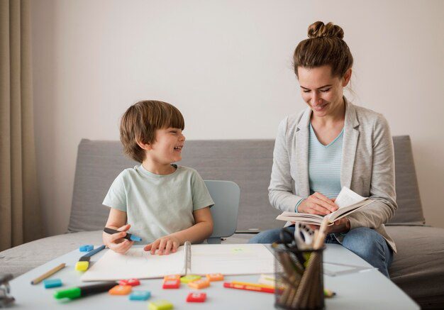front-view-child-being-tutored-home-by-woman_23-2148524537