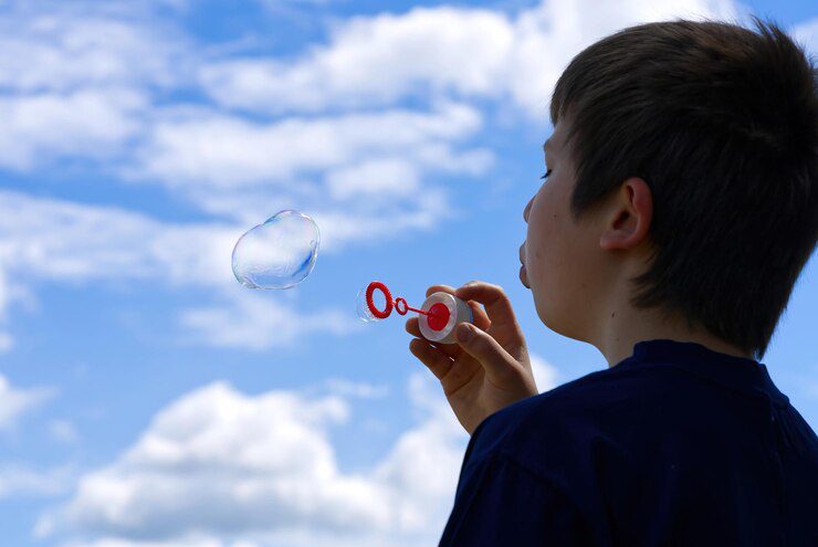 child-blows-soap-bubbles-nature_454608-882